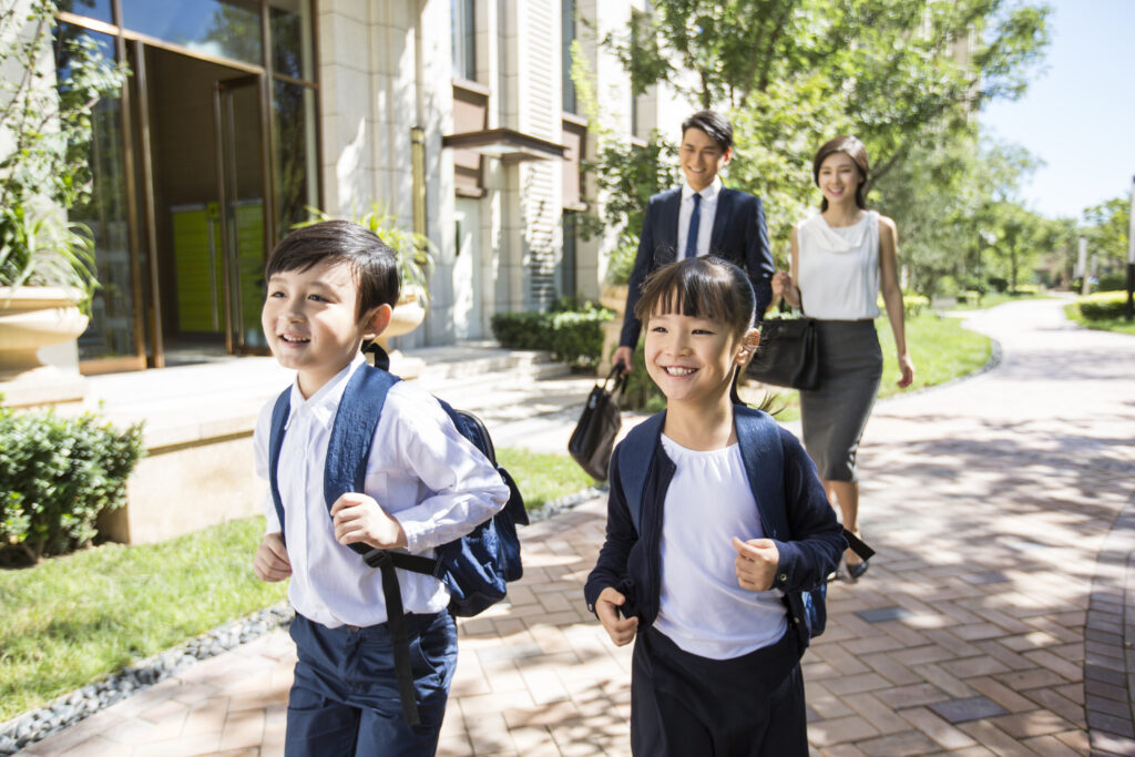 Happy Chinese sister and brother going to school