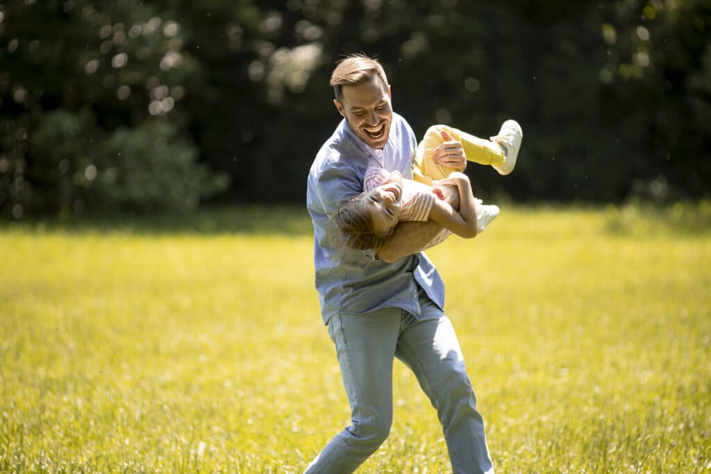 father playing with daughter