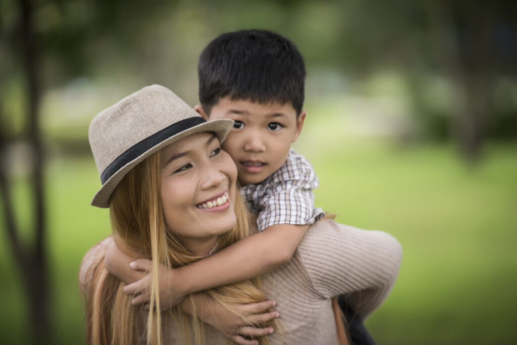 Happy young mother and son laughing