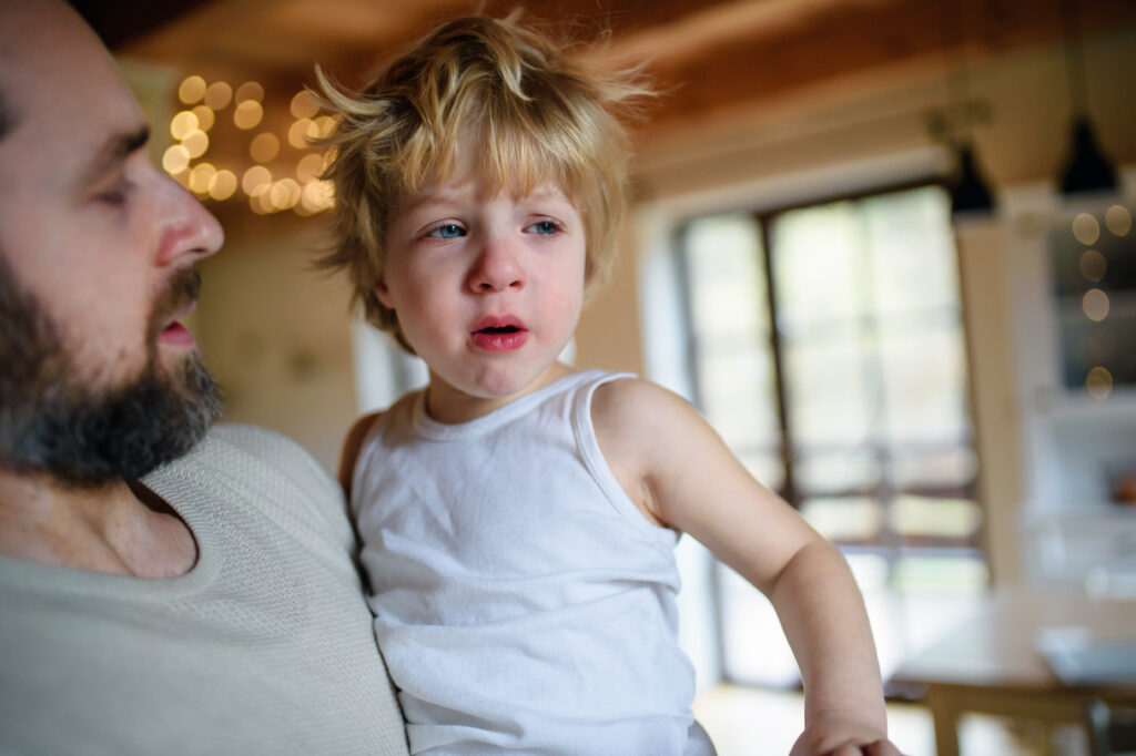 Father with small sick unhappy son