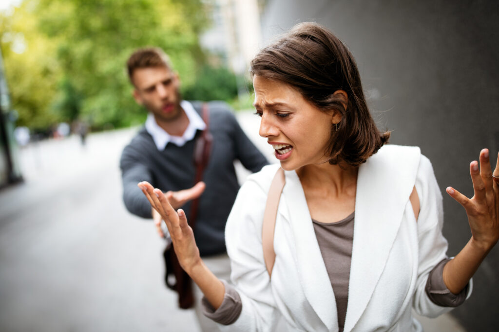 Frustrated couple arguing and having marriage problems outdoor