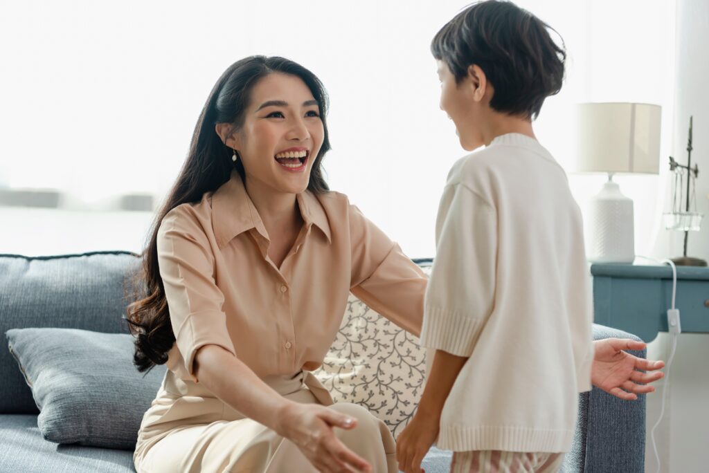 Happy Asian tender son hugging mother