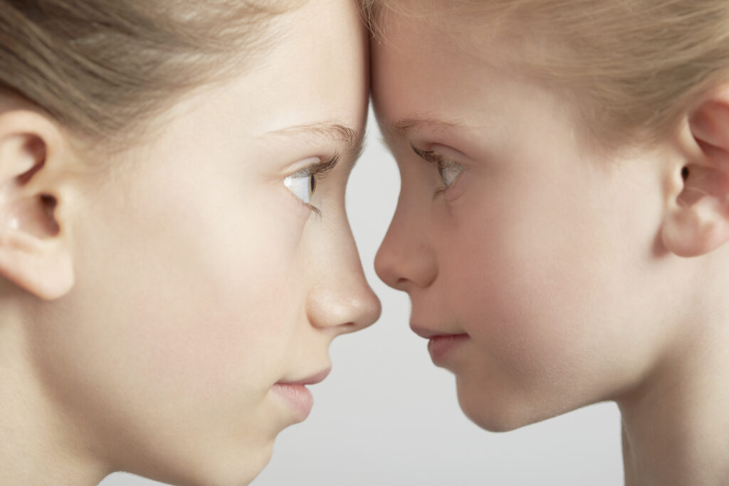 Portrait of two girls, face to face