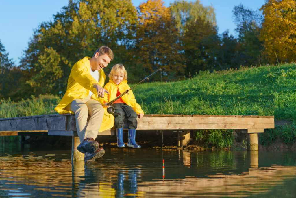 Dad and son fishing outdoors