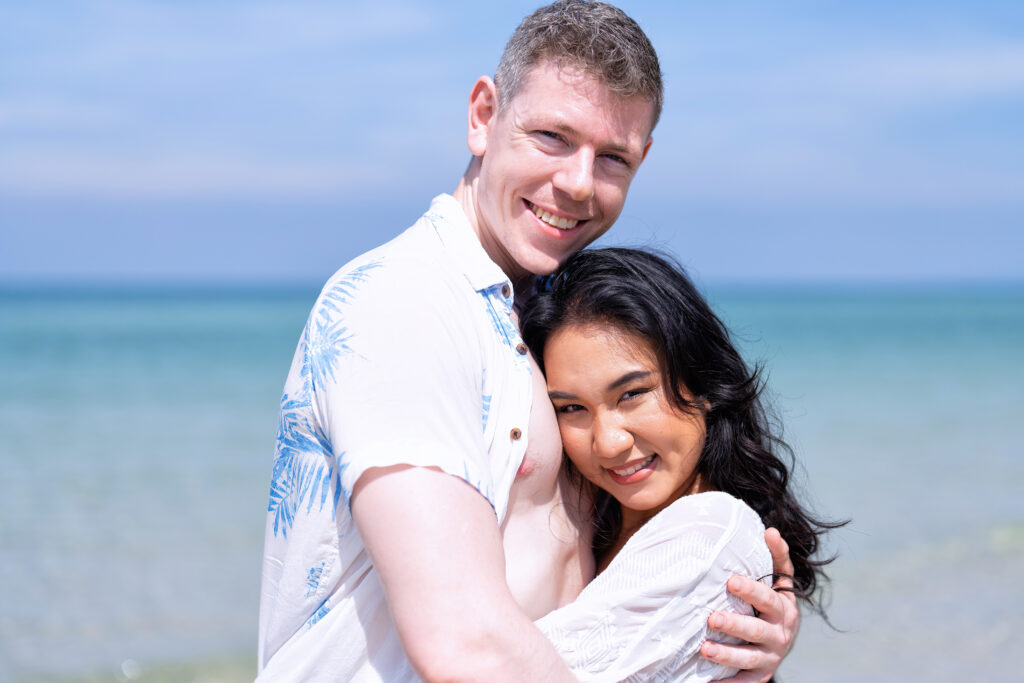 Love couple on holiday happy playing running along the beach