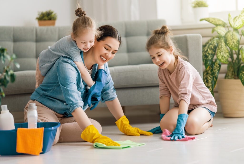 Mother and daughters doing the cleaning in the house