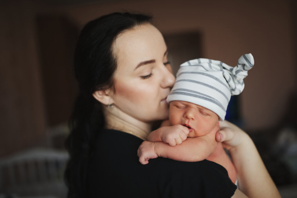 mother with newborn baby on shoulder