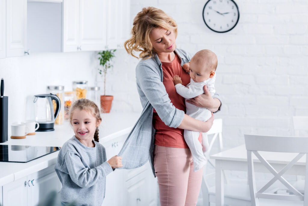 tired mother holding infant child